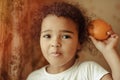 Child with oranges. Happy little girl with fruit. Royalty Free Stock Photo