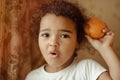 Child with oranges. Happy little girl with fruit. Royalty Free Stock Photo