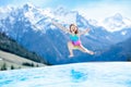 Child in outdoor swimming pool of alpine resort