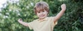 Child outdoors in nature. Happy child. Funny baby boy isolated on a background of green trees. Smiling child boy Royalty Free Stock Photo