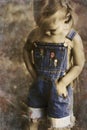 Child in overalls in vintage tones