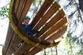 Child overcoming wooden pipe obstacle