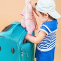 Child packs her things, clothes at luggage Royalty Free Stock Photo