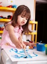 Child paint picture in preschool. Royalty Free Stock Photo