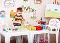 Child paint picture in preschool. Royalty Free Stock Photo