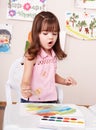 Child paint picture in preschool. Royalty Free Stock Photo