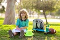 Child painter draw on playground. Kid boy create artist paints, summer vacation. School child drawing in summer park Royalty Free Stock Photo