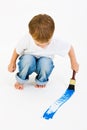 Child painting blue with a big brush Royalty Free Stock Photo