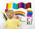 Child painting with brush, a lot of paints Royalty Free Stock Photo