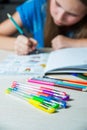 Child painting a coloring book. New stress relieving trend.