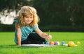 Child painting drawing art. Schooler kids drawing in summer park, painting art. Little painter draw pictures outdoor.