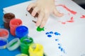 Child painting with fingers