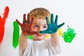 Child painting with messy hands