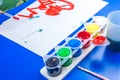 Child is painting a picture with tempera paints Royalty Free Stock Photo