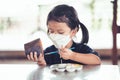 Child painting plant pot with watercolor. Kid wearing white face mask. Cute girl aged 4 years old Royalty Free Stock Photo