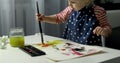 Child painting with watercolors