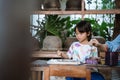 Child painting on white fabric