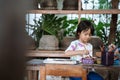 Child painting on white fabric