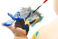 Child paints with paint your hand. creativity and artistic hobby