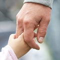 Child and parent holding hands