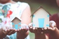 Child and parent holding paper house in hands Royalty Free Stock Photo