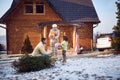 Child with parents bringing gifts and Christmas tree in house