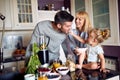 Child with parents having fun during breakfast