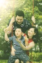 Child and parents playing with soap bubbles Royalty Free Stock Photo