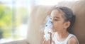 Child patient inhalation therapy by the mask of inhaler with soft stream smoke from bronchodilator.
