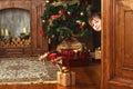 Child boy peeks out of the door with a christmas gift box Royalty Free Stock Photo