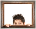 Child Peeking Out of Ornate Wooden Frame Royalty Free Stock Photo