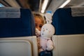Child peeking between seats.Child sitting in front seat.Children on plane/bus/train rides.Children in transportation. Annoying kid