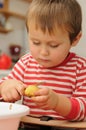 Child peeling potato Royalty Free Stock Photo