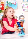 Child with pencil in play room. Royalty Free Stock Photo