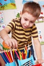 Child with pencil in play room. Royalty Free Stock Photo