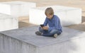 Child with phone. Boy looking at the screen, playing games, using apps. Outdoor. School people technology leisure