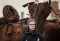 Child photographed near a burnt and melted rusty wreckage of a Soviet Russian-made tank Royalty Free Stock Photo