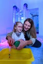 Child with physical disability in sensory stimulating room, snoezelen. Child living with cerebral palsy interacting with therapist Royalty Free Stock Photo