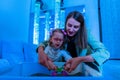 Child with physical disability in sensory stimulating room, snoezelen. Child living with cerebral palsy interacting with therapist