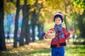 Child picking apples in autumn. Little baby boy playing in apple tree orchard. Kids pick fruit in a basket. Toddler eating fruits Royalty Free Stock Photo