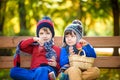 Child picking apples on a farm in autumn. Little boy sitting on bench in apple tree orchard. Kids pick fruit in a basket. Toddler Royalty Free Stock Photo