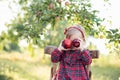 Child picking apples on farm in autumn. Little girl playing in apple tree orchard. Healthy nutrition Royalty Free Stock Photo