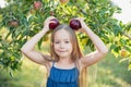 Child picking apples on farm in autumn. Little girl playing in apple tree orchard. Healthy nutrition Royalty Free Stock Photo