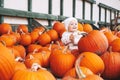 Child picking pumpkins at pumpkin patch