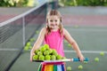 Child playing tennis on outdoor court