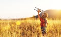 Child pilot aviator with airplane dreams of traveling in summer