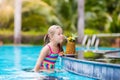 Child with pineapple juice in pool bar Royalty Free Stock Photo