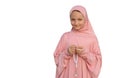 A child in a pink hijab with a beads in his hands isolated on white background. People religious lifestyle concept Royalty Free Stock Photo