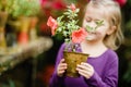 Toddler with flower basket. girl holding pink flowers Royalty Free Stock Photo