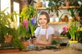 Child planting spring flowers. Little girl gardener plants hyacinth. Girl holding hyacinth in flower pot. Child taking Royalty Free Stock Photo